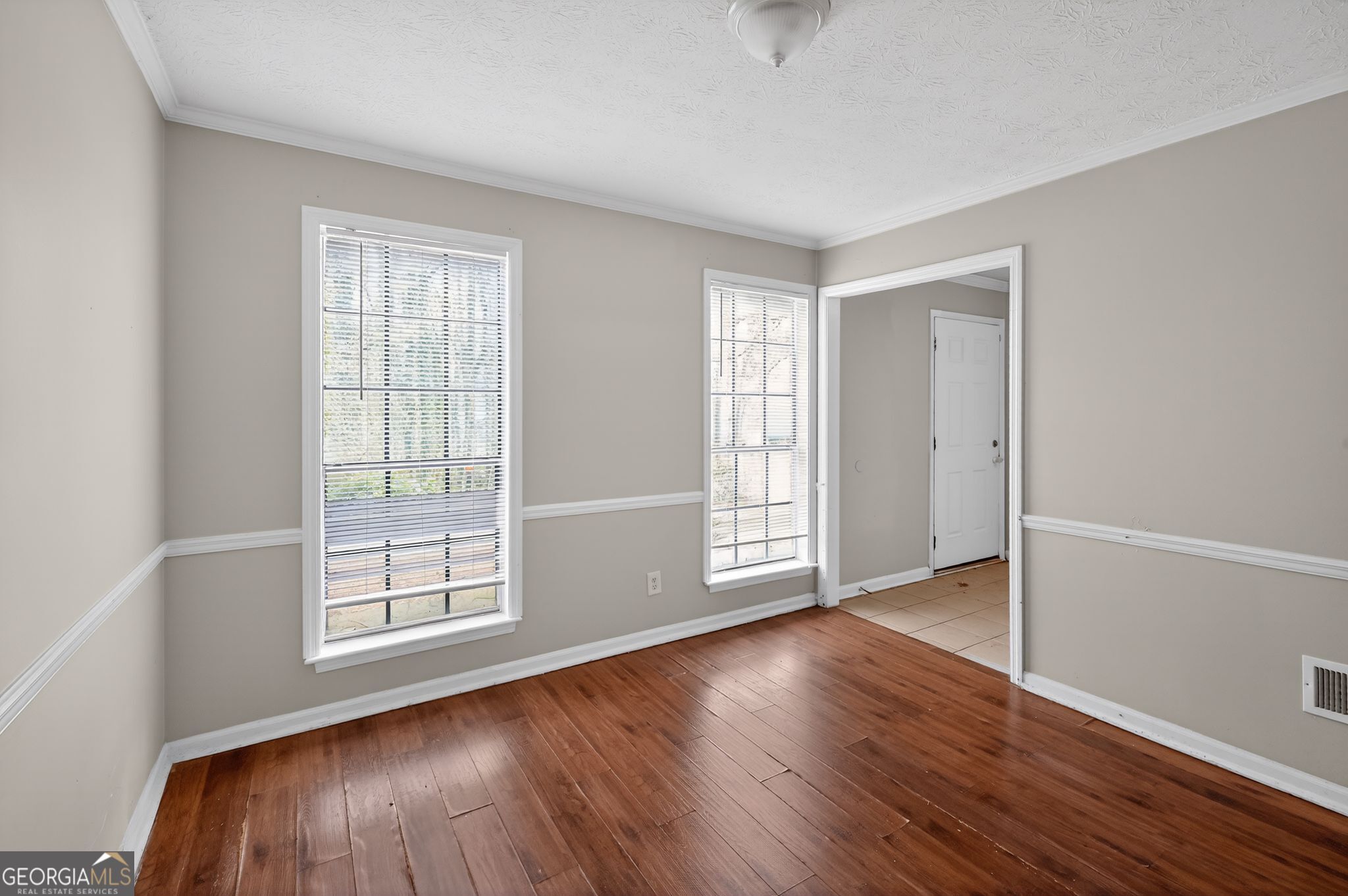 4629 ROUSAY Court Stone Mountain, GA 30083 - Photo 10 of 33 an empty room with wooden floor and windows