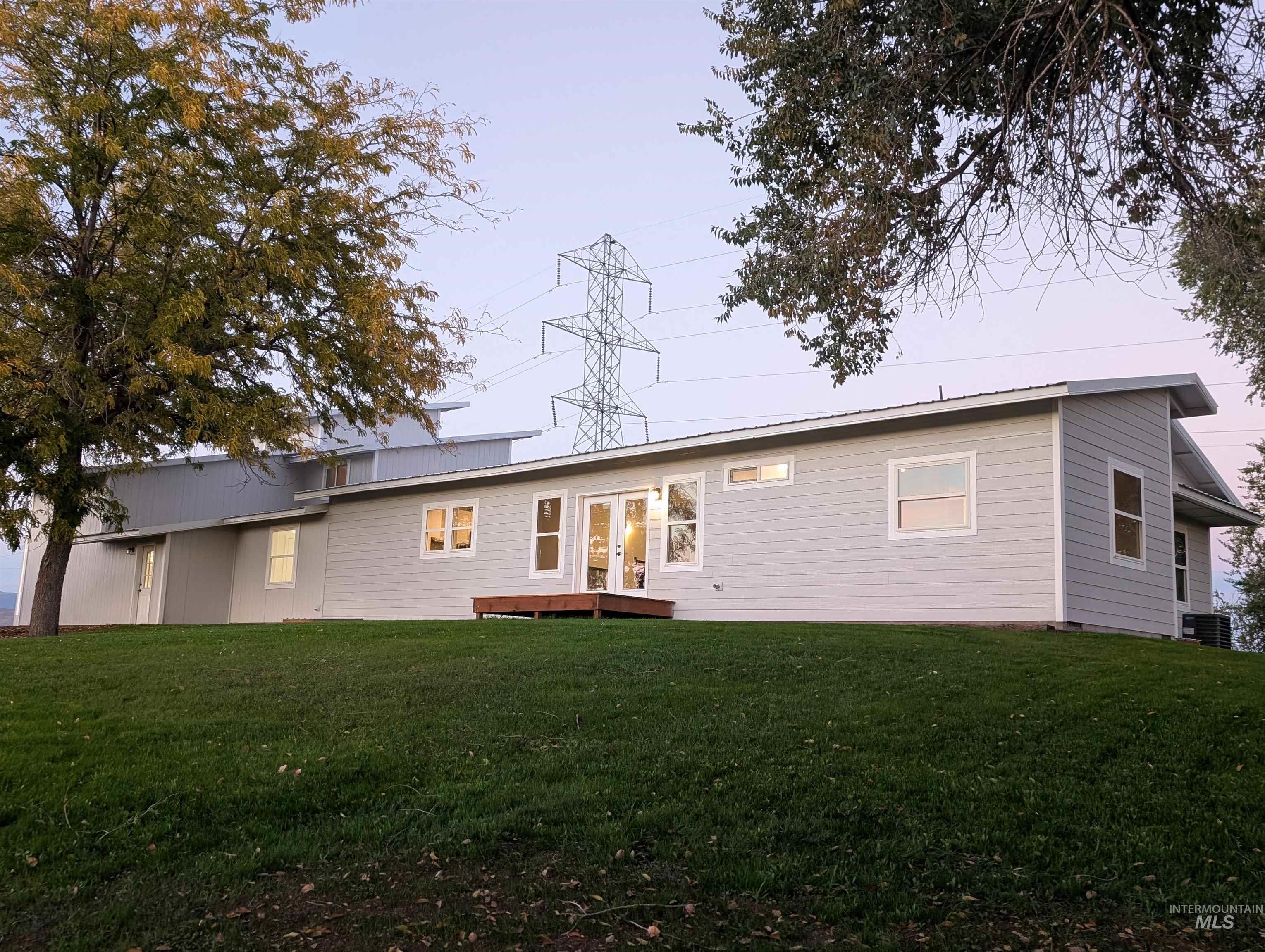 2253 Waite Road Midvale, ID 83645 - Photo 16 of 49 Rear view of house featuring a yard, a metal roof, and french doors