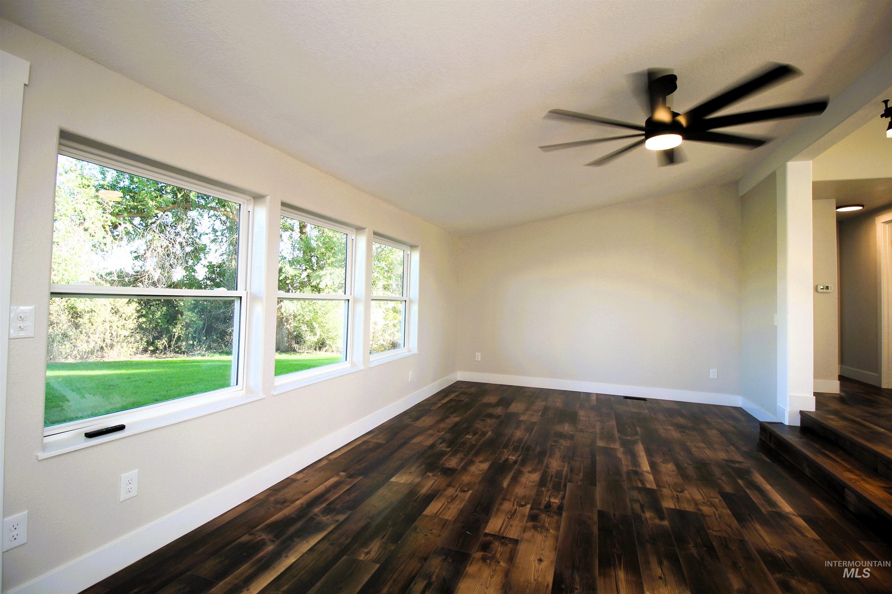 2253 Waite Road Midvale, ID 83645 - Photo 19 of 49 Spare room featuring lofted ceiling, dark wood-style flooring, and ceiling fan