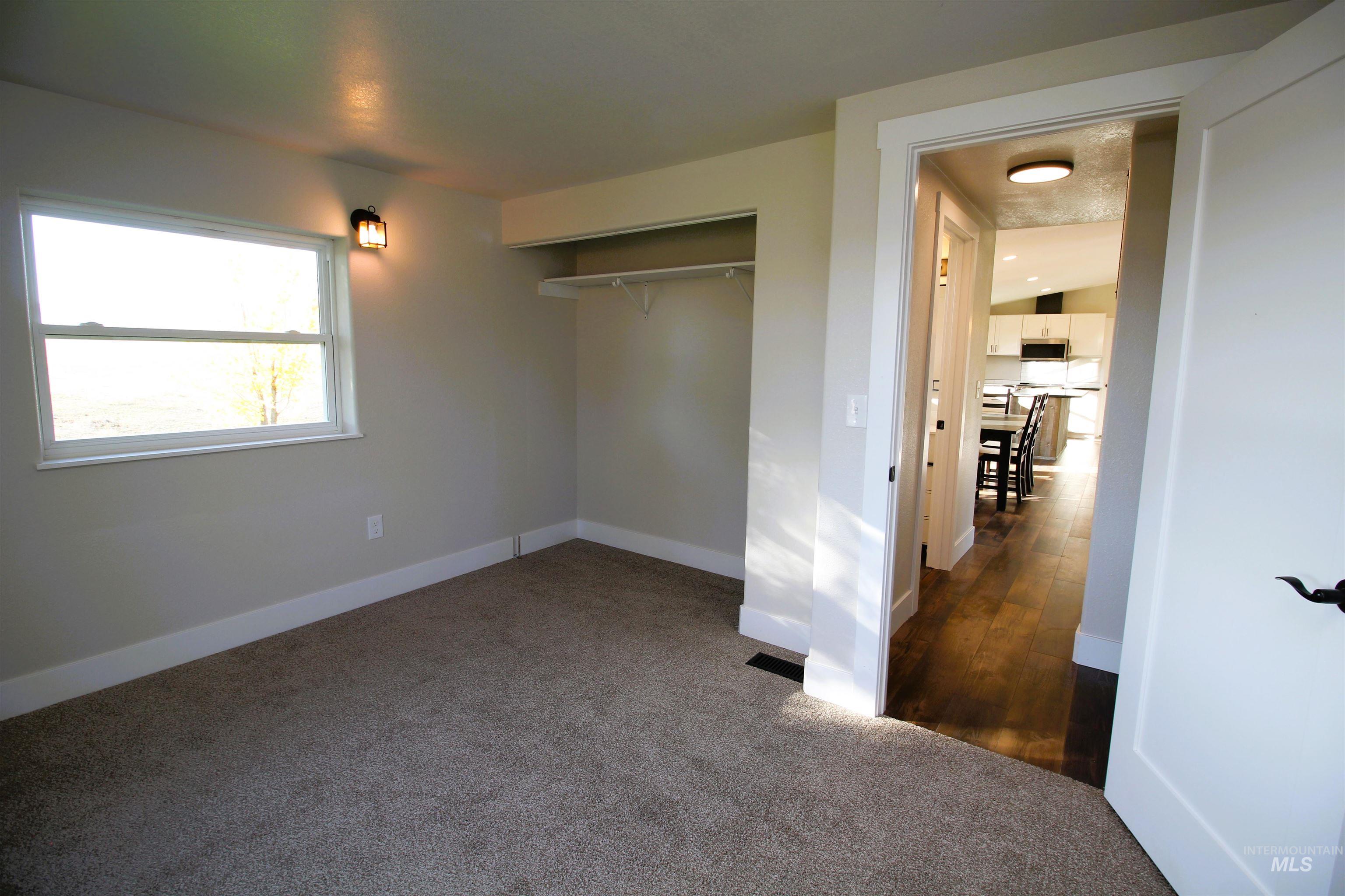 2253 Waite Road Midvale, ID 83645 - Photo 26 of 49 Unfurnished bedroom featuring dark carpet and a closet
