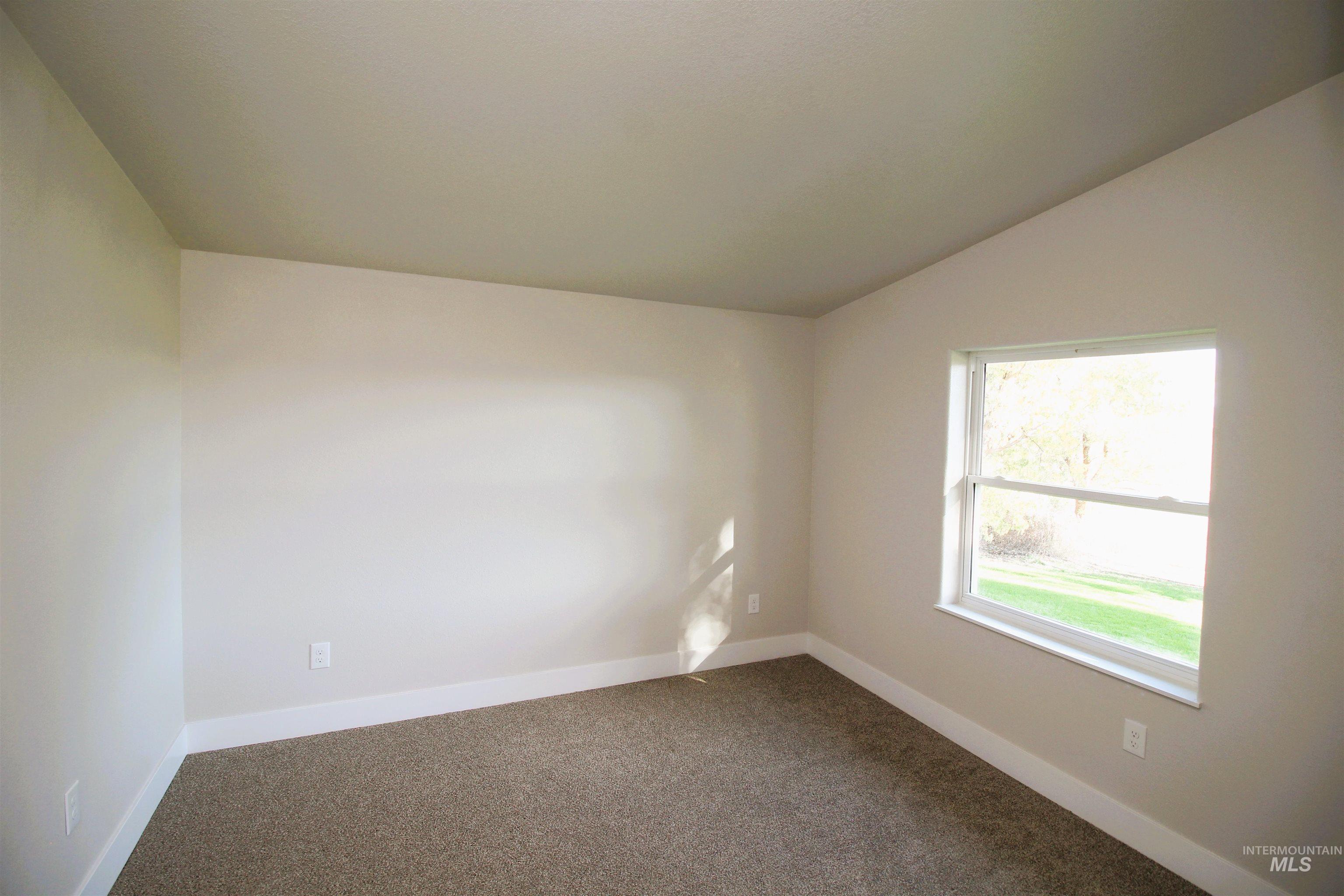2253 Waite Road Midvale, ID 83645 - Photo 27 of 49 Carpeted spare room featuring baseboards and lofted ceiling