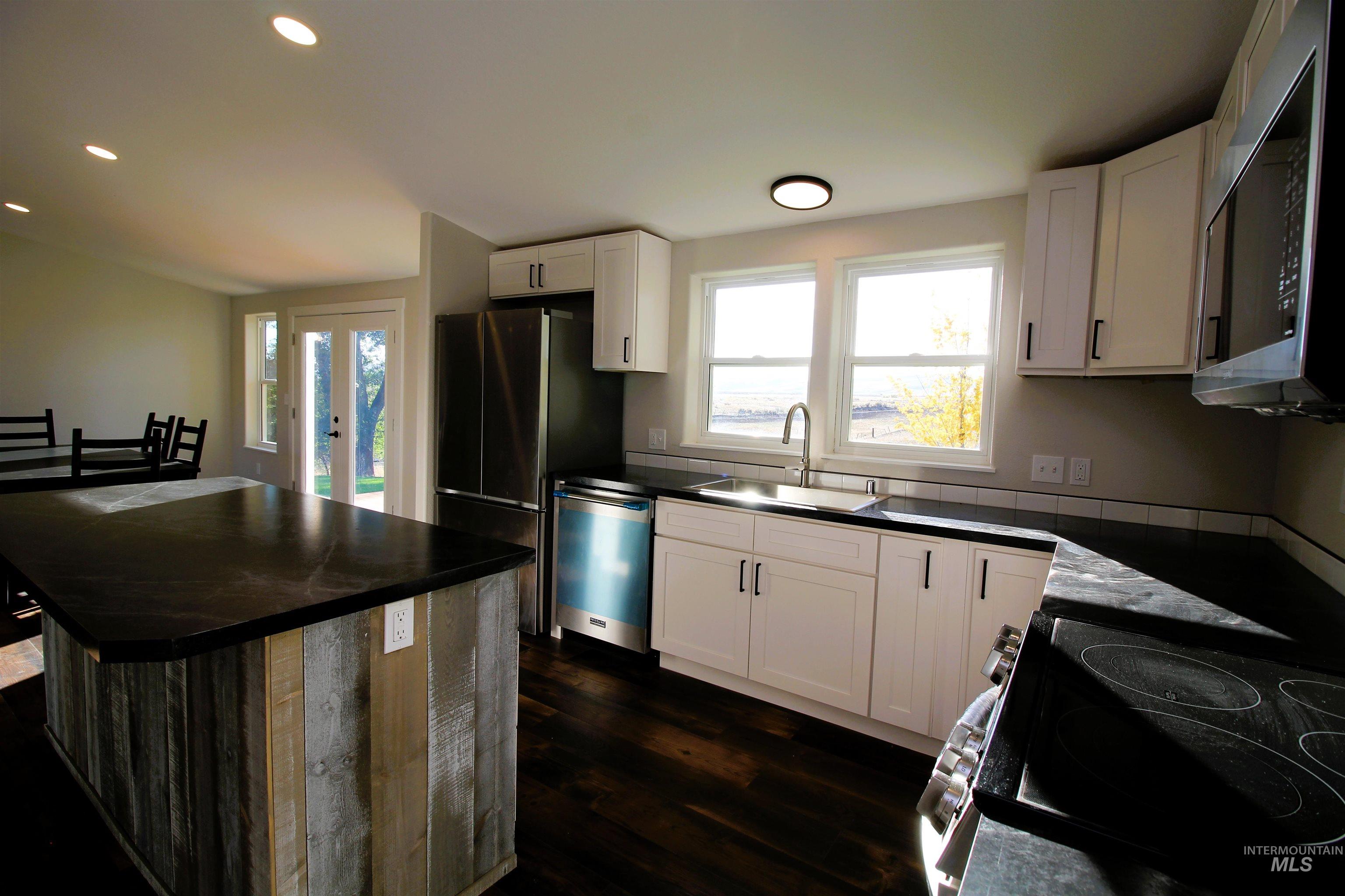 2253 Waite Road Midvale, ID 83645 - Photo 33 of 49 Kitchen featuring a kitchen island, recessed lighting, healthy amount of natural light, stainless steel appliances, and dark wood-type flooring