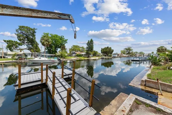 a view of a lake with chairs in front of house