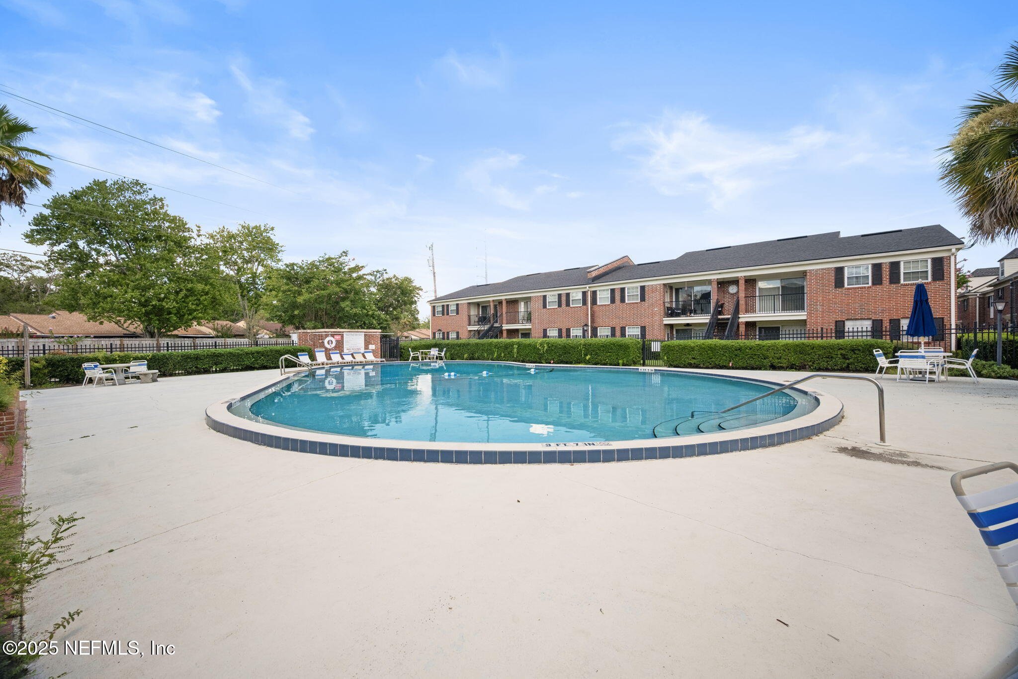 4915 Baymeadows Road, Unit 8H Jacksonville, FL 32217 - Photo 18 of 20 a view of a white house with a sink and a yard