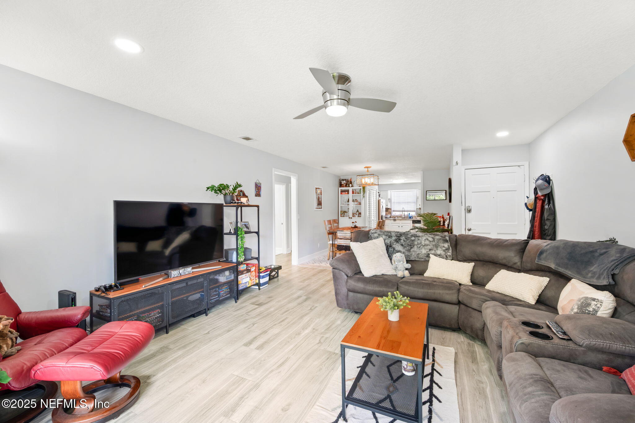 4915 Baymeadows Road, Unit 8H Jacksonville, FL 32217 - Photo 5 of 20 a living room with furniture and a flat screen tv