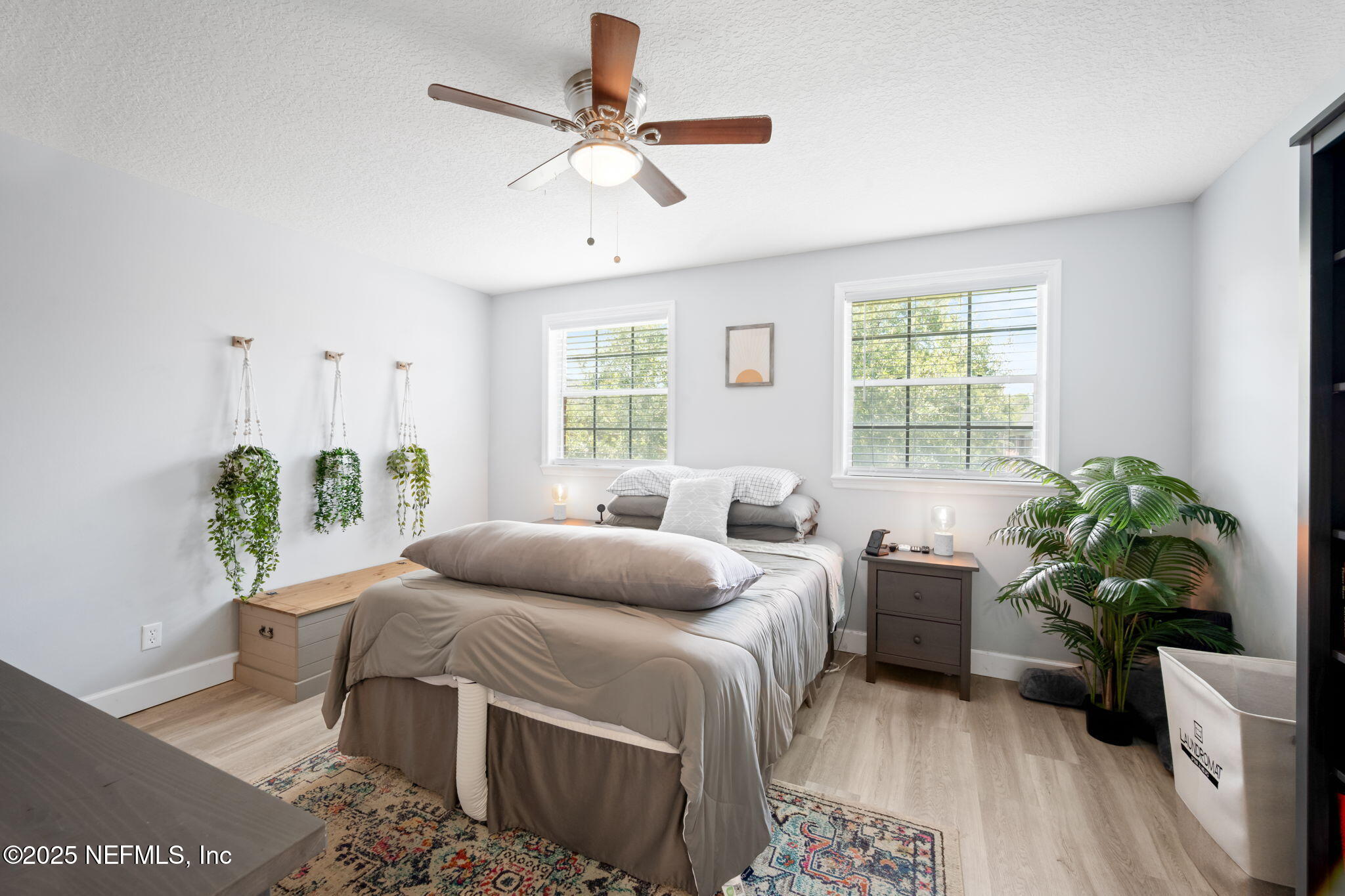 4915 Baymeadows Road, Unit 8H Jacksonville, FL 32217 - Photo 10 of 20 a bedroom with a bed table flowerpot and window