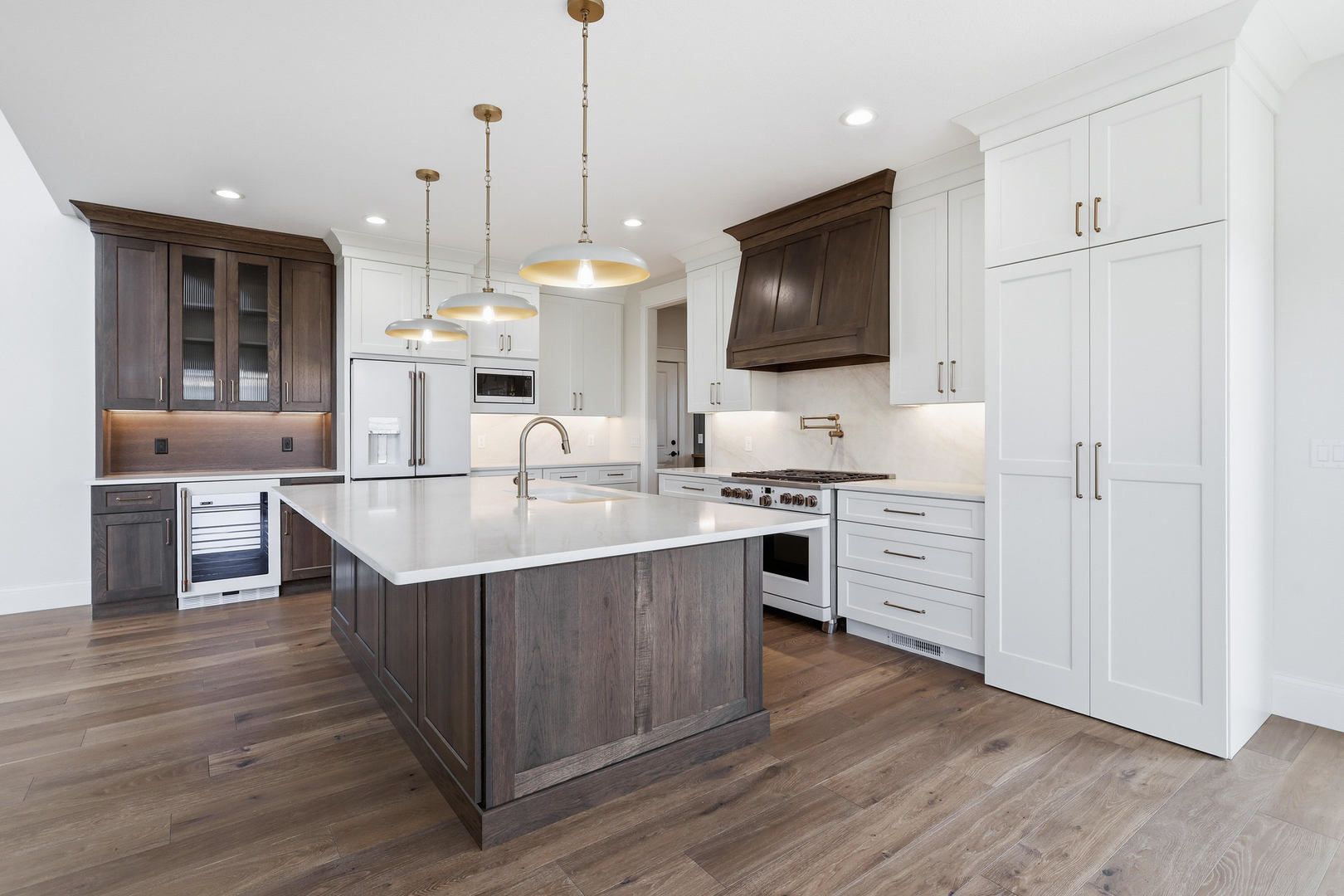 6928 Wilderness Pointe Bettendorf, IA 52722 - Photo 21 of 48 a kitchen with stainless steel appliances granite countertop a sink a stove and a wooden floor