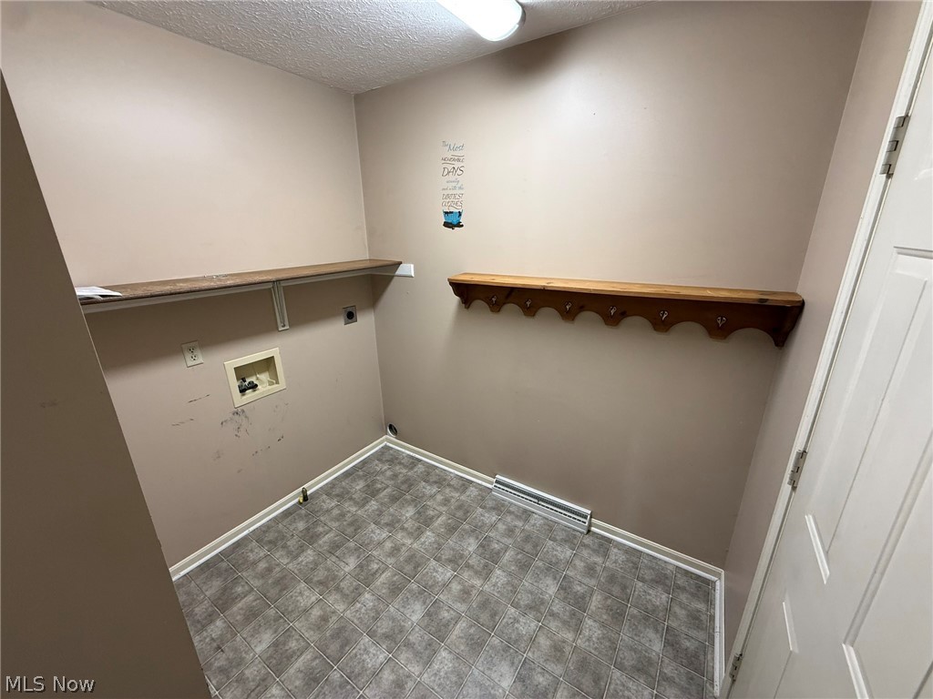 604 Harger Street Dover, OH 44622 - Photo 7 of 25 Laundry room with a textured ceiling, hookup for a washing machine, and electric dryer hookup