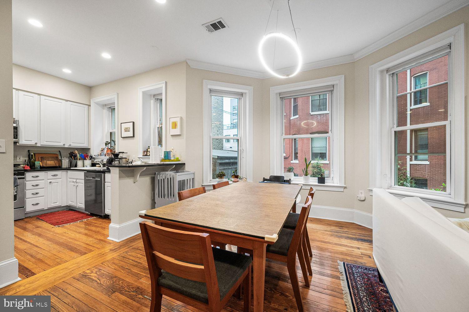 1423 R Street Northwest, Unit 105 Washington, DC 20009 - Photo 11 of 32 a kitchen with a table chairs sink and cabinets