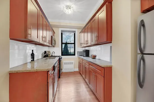 a kitchen with stainless steel appliances granite countertop a sink stove and refrigerator