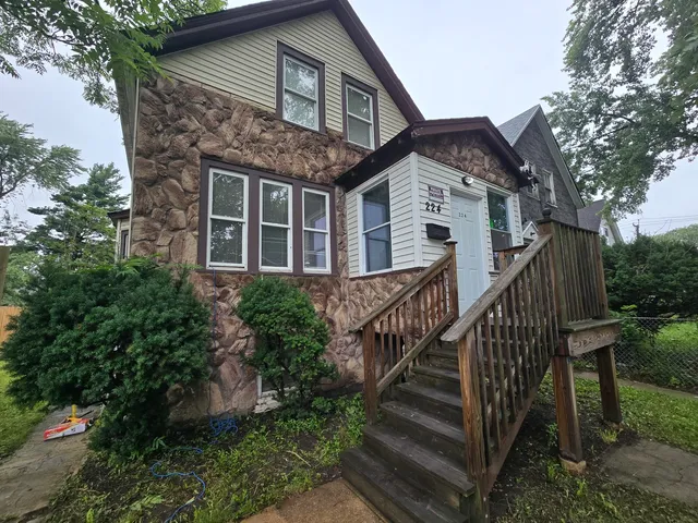 a front view of house with deck and yard