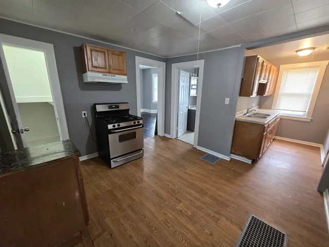 a kitchen with granite countertop a stove and a refrigerator