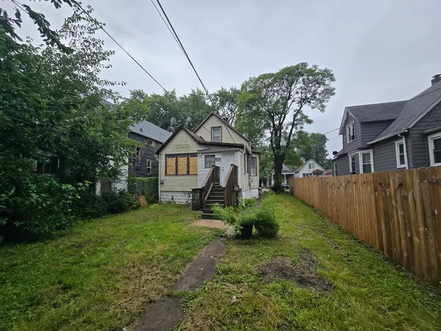 a view of a house with wooden fence