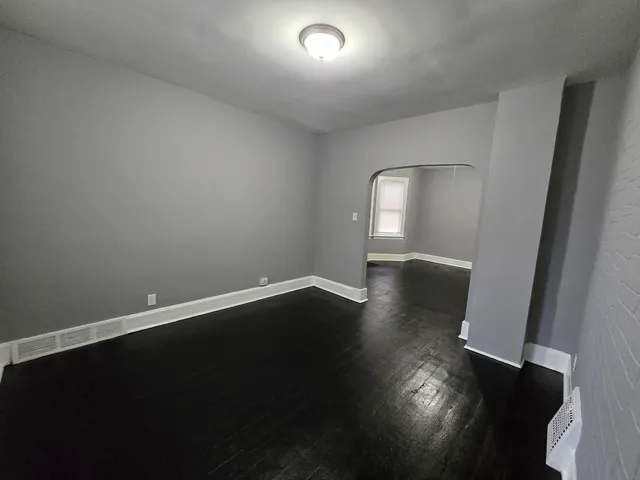 a view of wooden floor and windows in a room