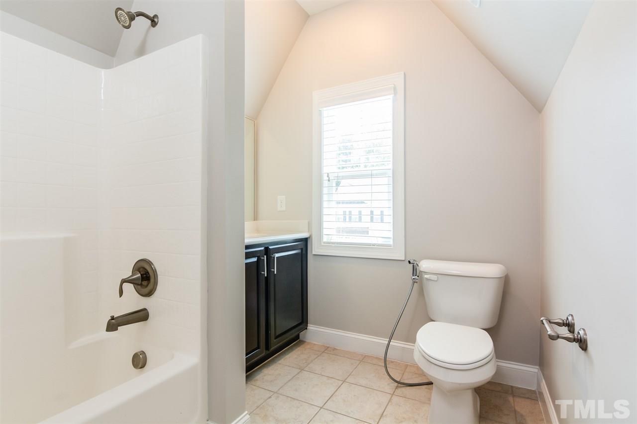 5646 Wade Park Boulevard Raleigh, NC 27607 - Photo 16 of 20 a white toilet sitting next to a bath tub