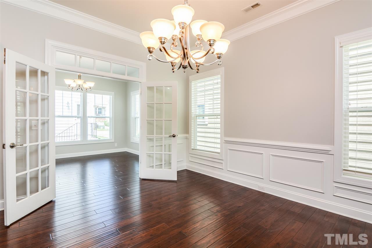 5646 Wade Park Boulevard Raleigh, NC 27607 - Photo 7 of 20 a view of an empty room with wooden floor and a window