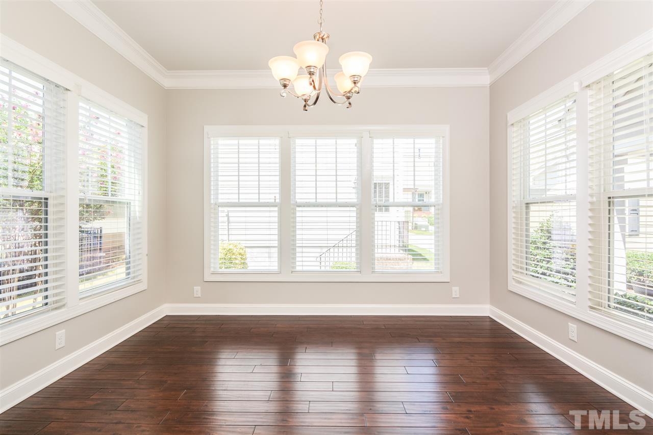 5646 Wade Park Boulevard Raleigh, NC 27607 - Photo 8 of 20 a view of an empty room with wooden floor and a window