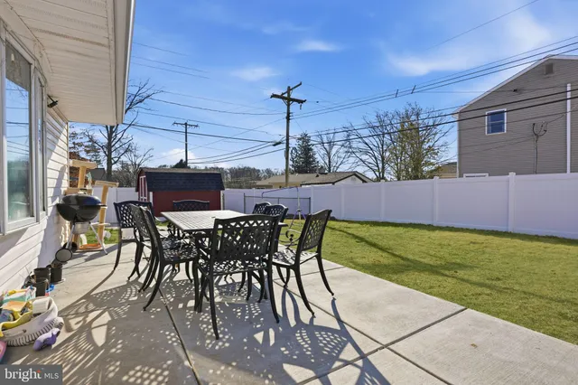a patio with table and chairs