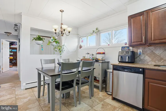 a kitchen with kitchen island granite countertop a table and chairs in it