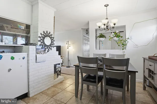 a view of a dining room with furniture and chandelier