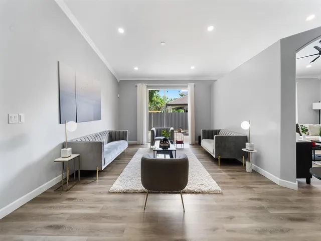 a living room with furniture or couch and a potted plant