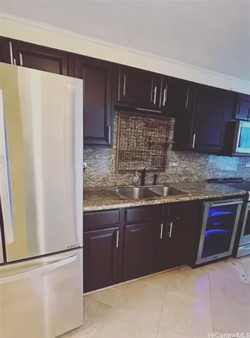 a kitchen with stainless steel appliances granite countertop a refrigerator and a sink