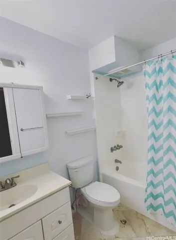 a bathroom with a sink toilet vanity and shower