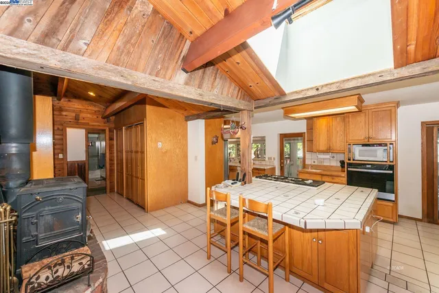 a kitchen view with a table and chairs in it