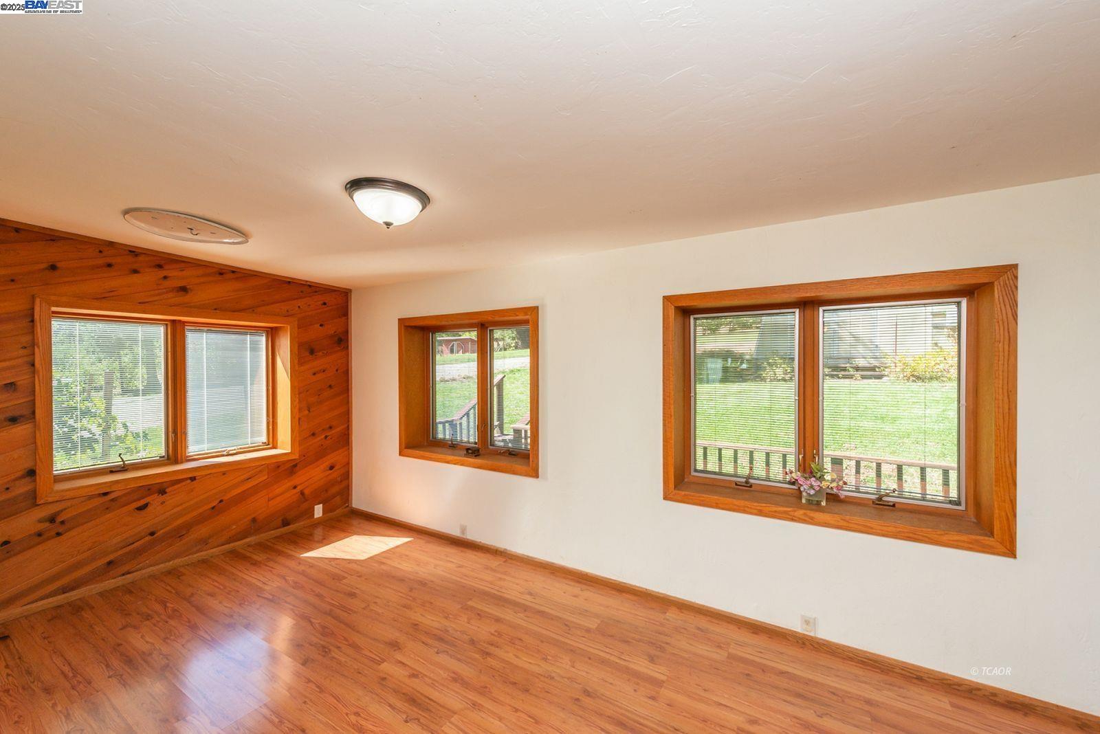 4481 Rush Creek Road Lewiston, CA 96052 - Photo 18 of 50 a view of an empty room with wooden floor and a window