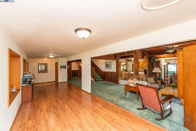 a view of a livingroom with furniture hardwood floor and windows