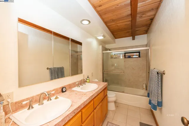a view of a kitchen with stainless steel appliances granite countertop a sink and a cabinets
