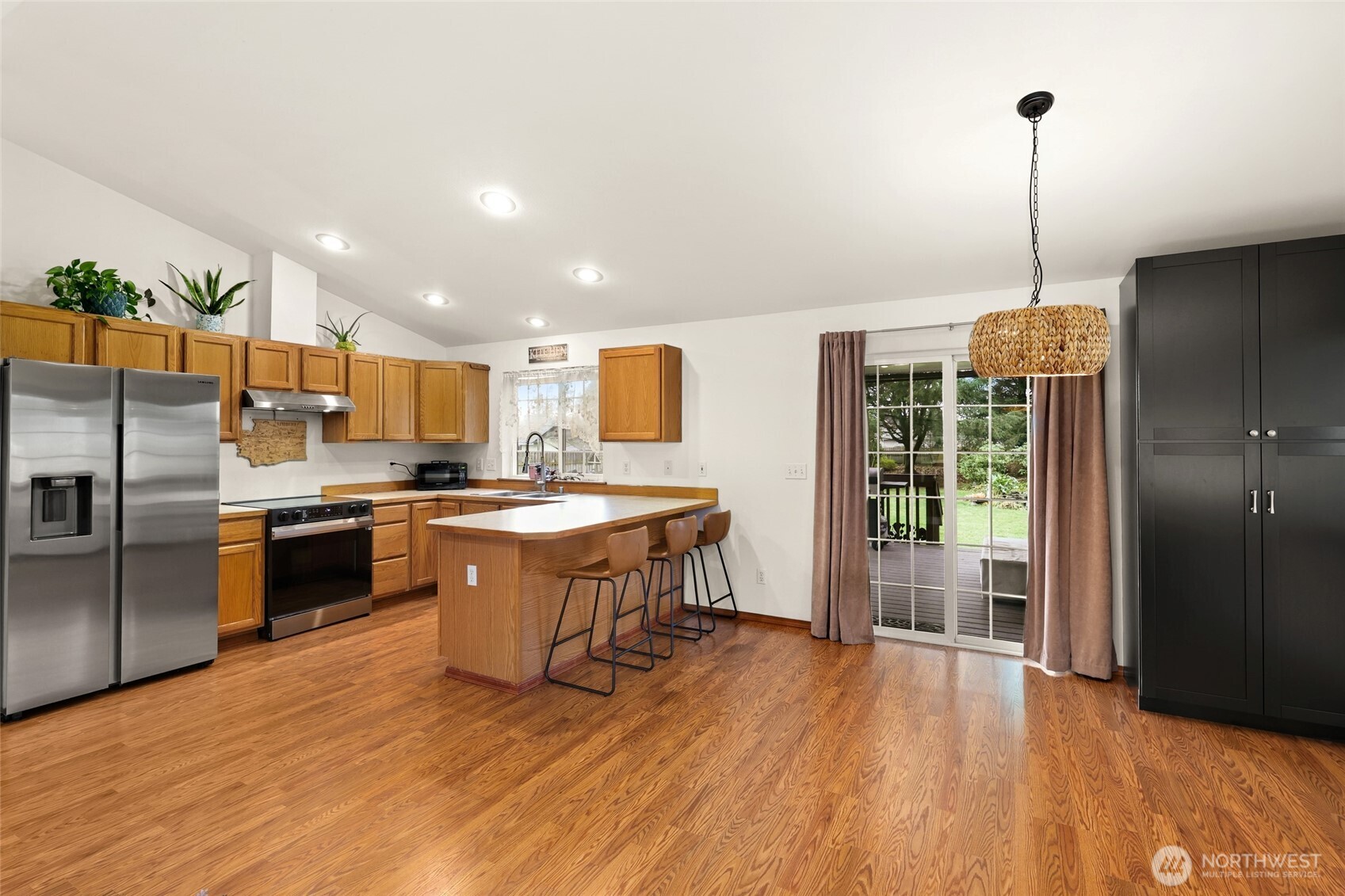 18207 Keona Lane Southwest Rochester, WA 98579 - Photo 11 of 35 a kitchen with stainless steel appliances granite countertop a refrigerator a sink dishwasher a stove and a wooden floor