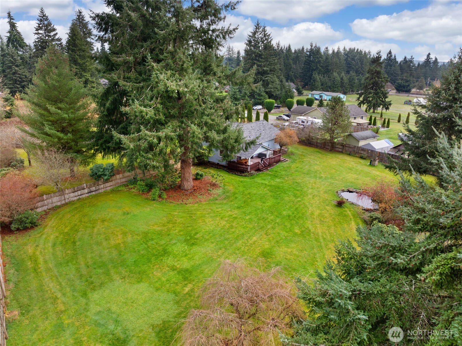 18207 Keona Lane Southwest Rochester, WA 98579 - Photo 34 of 35 a backyard of a house with lots of green space and mountain view