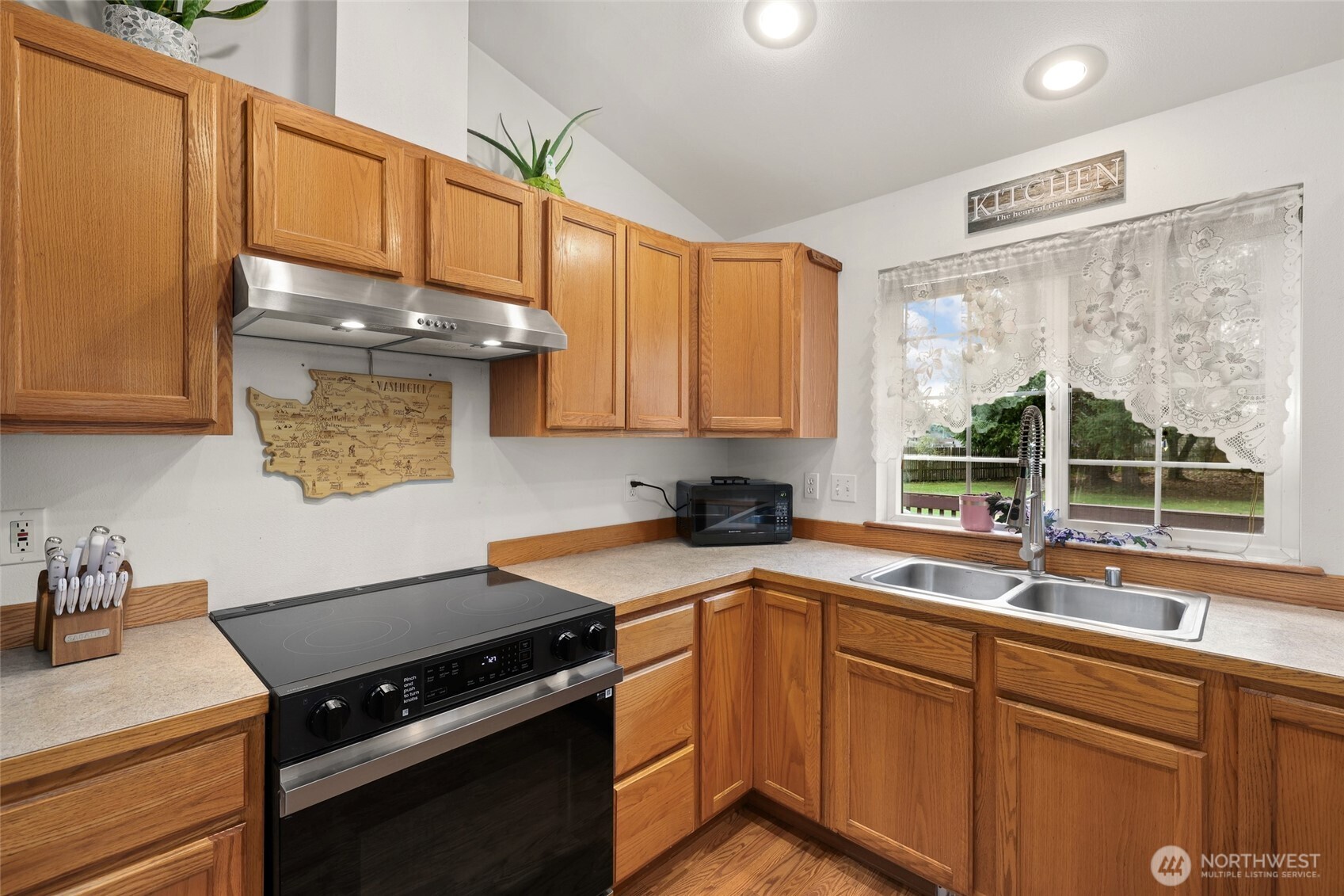 18207 Keona Lane Southwest Rochester, WA 98579 - Photo 6 of 35 a kitchen with a sink stove top oven and cabinets