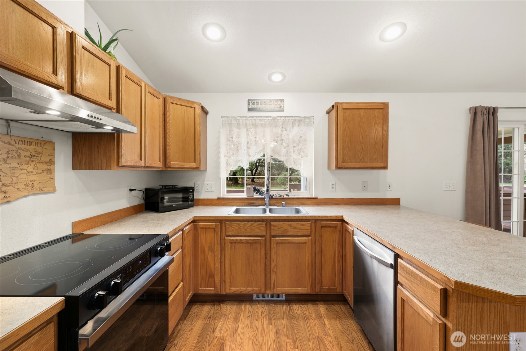 18207 Keona Lane Southwest Rochester, WA 98579 - Photo 7 of 35 a kitchen with a sink stove and cabinets
