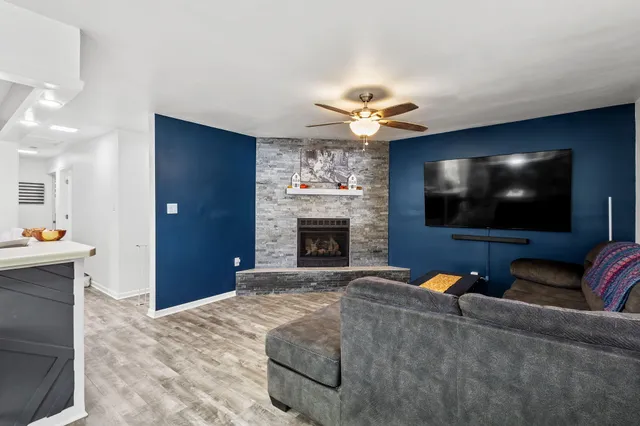 a living room with furniture a fireplace and a flat screen tv