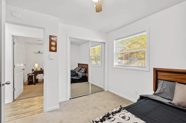 a view of a livingroom with wooden floor and a flat screen tv