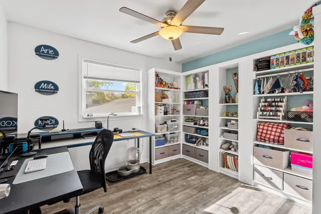 a view of a workspace with furniture and a bookshelf