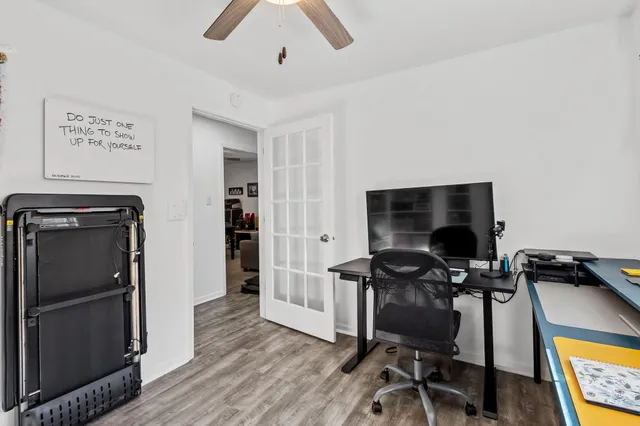 a view of a workspace with furniture and wooden floor