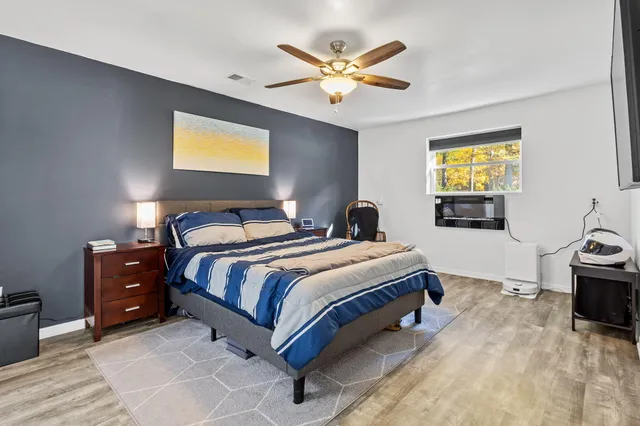 a bedroom with bed and window