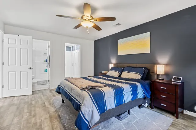 a bedroom with a bed and a chandelier