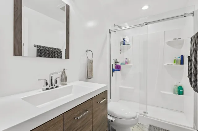 a bathroom with a sink toilet and shower