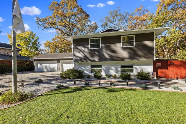 a backyard of a house with table and chairs