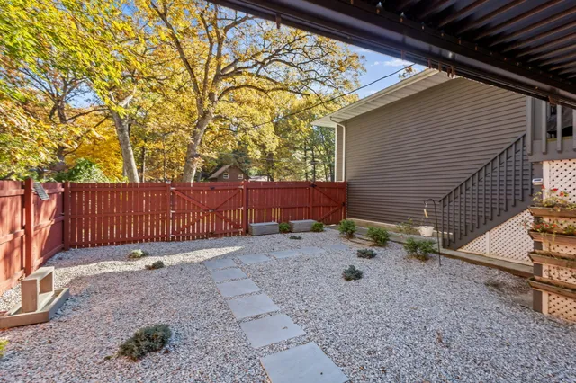 a outdoor space with the couches and dining table with the garden view