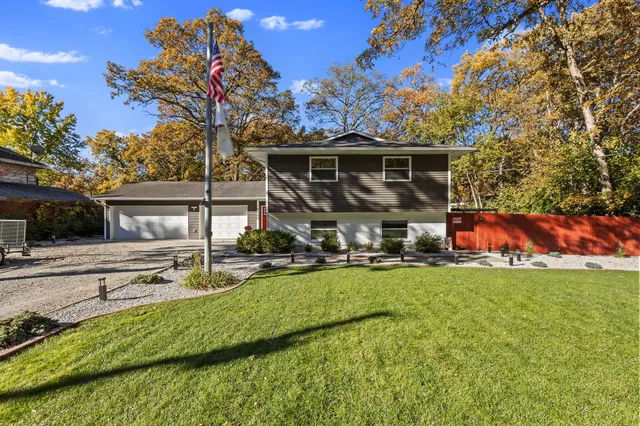 a view of a house with backyard and sitting area