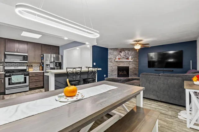 a kitchen with stainless steel appliances wooden floor a stove and cabinets