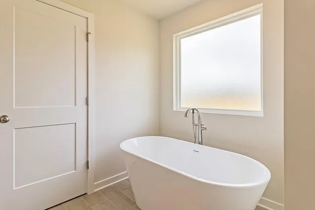 a white bath tub sitting next to a white sink