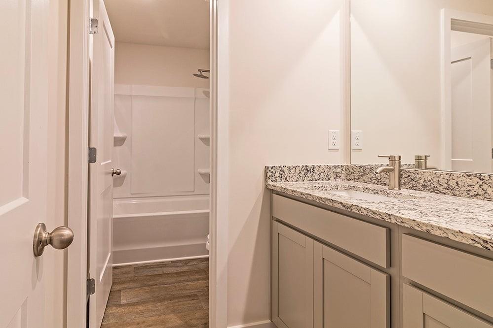 148 Post Oak Drive Jackson, GA 30233 - Photo 20 of 20 a bathroom with a granite countertop sink and a mirror