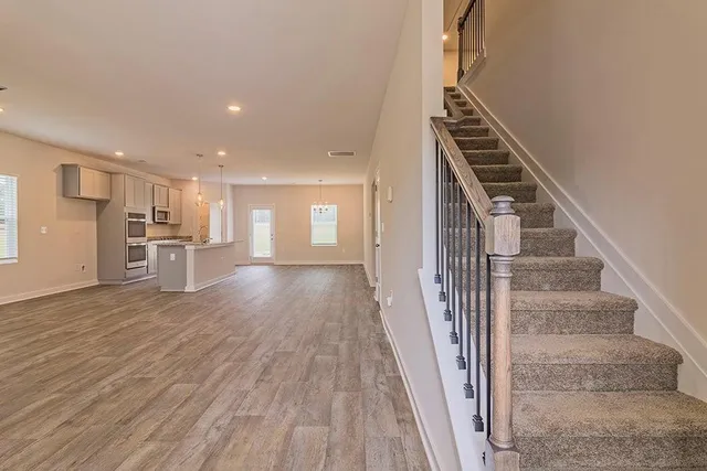 a view of a kitchen with wooden floor and electronic appliances