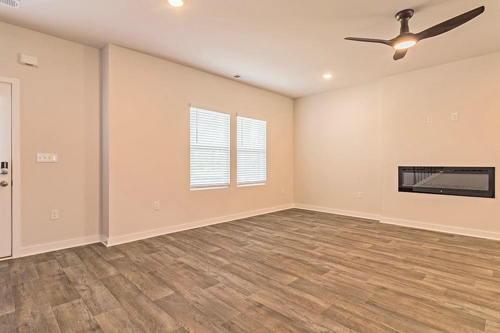 148 Post Oak Drive Jackson, GA 30233 - Photo 5 of 20 a view of empty room with wooden floor and fan